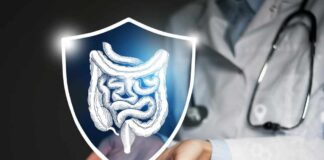 A doctor holding a digital shield with a graphic of the digestive system