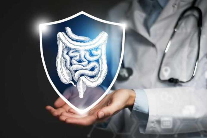 A doctor holding a digital shield with a graphic of the digestive system