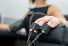 Bizarre Breathing Trick Slashes Blood Pressure Close-up of a patients hand during a medical examination with monitoring equipment