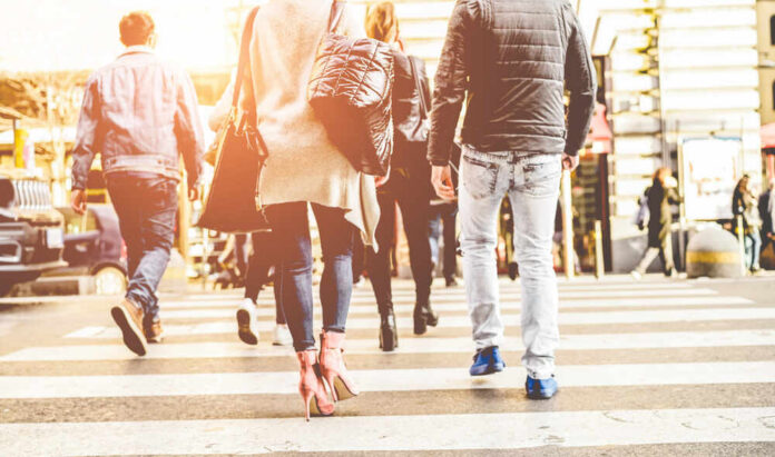 Group of pedestrians crossing a street in an urban setting