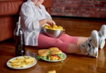Child sitting on the floor enjoying snacks from a bowl