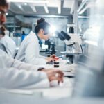 Gene Mutation Shocks Fatty Liver Science Scientists working in a laboratory with microscopes and test tubes