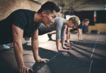 Exercise Rewrites Brain Aging Rules Group of individuals performing push-ups in a gym