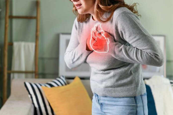 Woman holding her chest in discomfort with a heart illustration
