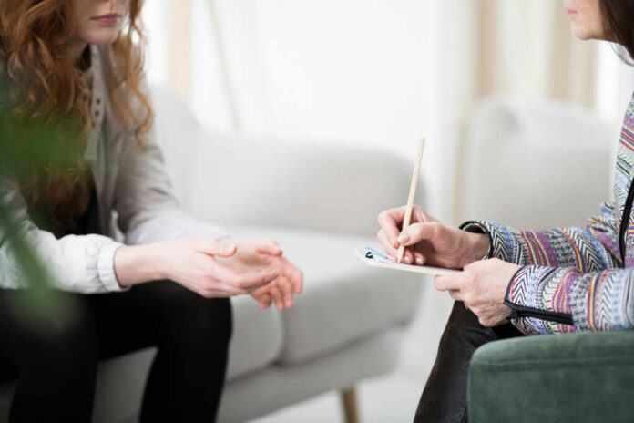 shutterstock1096053290jpg-1 Two individuals engaged in a counseling session, one taking notes