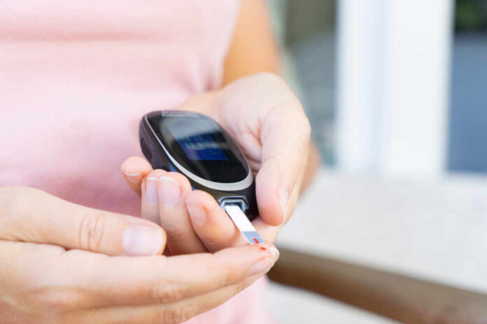 Measuring,Blood,Sugar,Level,With,Blood,Glucose,Metr,,World,Diabetes Person using a blood glucose meter to check their levels