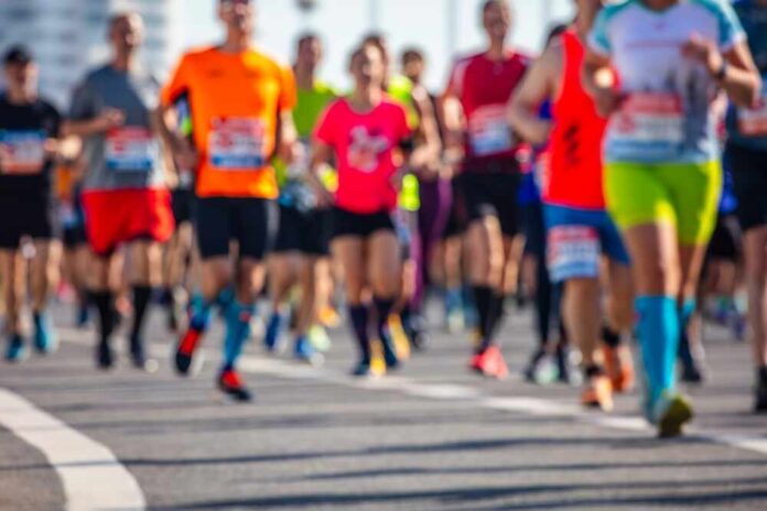 shutterstock_2403435149.jpg A group of runners participating in a marathon on a sunny day