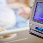 Hidden Deficiency Flags Post-Surgery Agony IV pump displaying medication flow rate in a hospital room