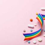FDA-approved Drug Cracks Cancer’s Invisible Wall Colorful pills and a rainbow ribbon on a pink background
