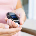 Overlooked Plant Compound Found To Cut Blood Sugar Person using a blood glucose meter to check their levels