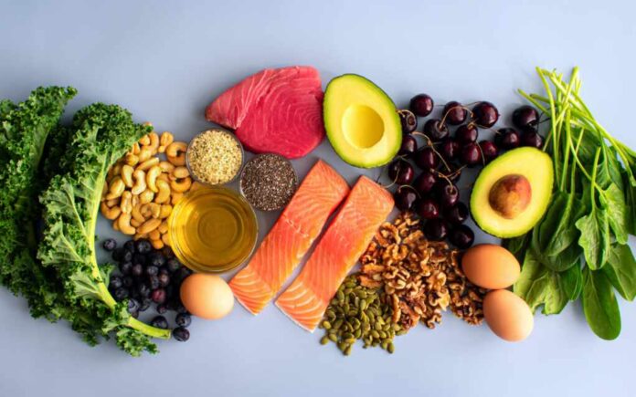 Overhead,View,Of,Fresh,Omega-3,Rich,Foods:,A,Variety,Of An assortment of healthy foods including fish, nuts, fruits, and vegetables arranged on a light background