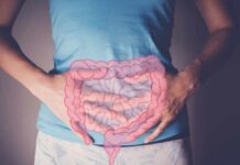 Travel Constipation: Causes, Prevention and Relief Person holding their stomach with a graphic of intestines overlayed