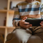 Algorithm Trap That Targets Vulnerable Girls Child sitting on a couch, holding a smartphone and focused on the screen