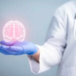 AI Reading Brains—Mayo Bets Big A medical professional holding a glowing digital brain illustration in their hand