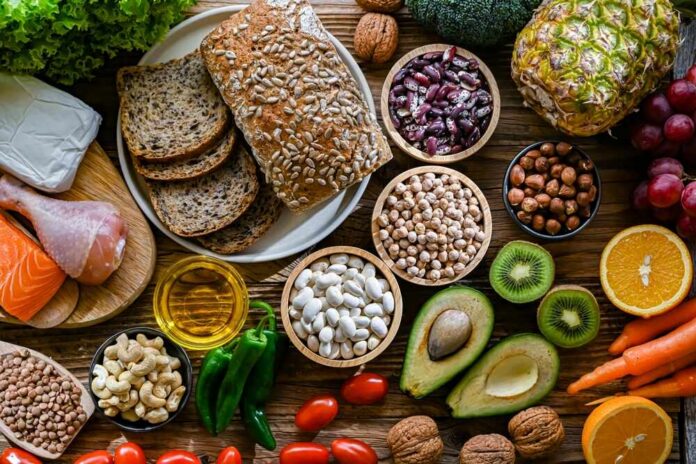 Food,Products,Representing,The,Dash,Diet,Which,Was,Created,To A variety of fresh foods including vegetables, fruits, grains, and proteins arranged on a wooden surface