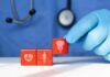 Frequent urination in women: Ways to find relief A doctor's gloved hand placing red blocks with health symbols on a table
