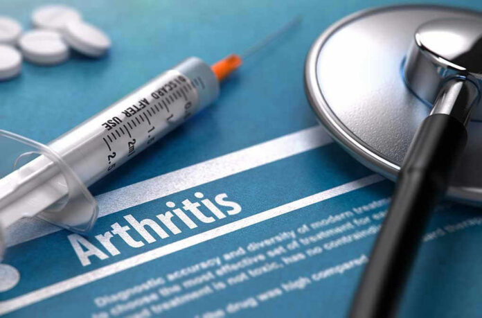 Syringe and stethoscope on arthritis document
