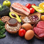 Assorted healthy foods arranged on a dark surface