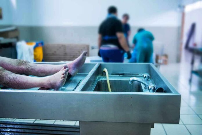 shutterstock_1118577194 cadaver on stainless autopsy table in clinical room