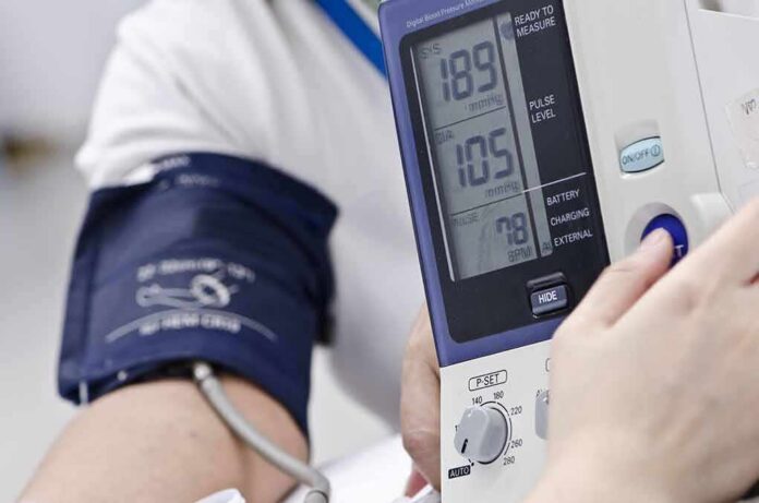 shutterstock_152502707 Person having blood pressure measured with digital monitor