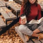 Woman reading a book on outdoor bleachers