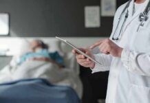 Silent Hunch Tied To Early Death Doctor using tablet beside hospital patient