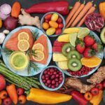 Assorted fruits, vegetables, and salmon slices on plates