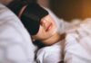 Aging Slowed by Sleep? Biobank Bombshell Woman sleeping with a black eye mask in bed
