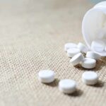 Cheap Diabetes Pill Takes On Aging White tablets spilling from a plastic bottle