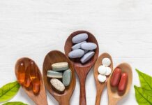 Assorted dietary supplements on wooden spoons