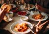 Pasta dinner with wine on a sunlit table