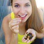 Woman eating mixed nuts and seeds
