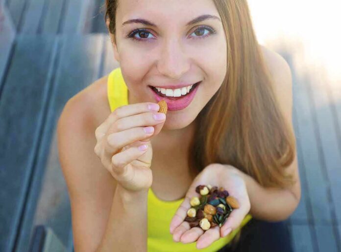 Woman eating mixed nuts and seeds
