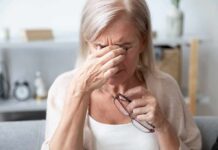 Stop Tears FAST With This Bizarre Fix Older woman rubbing the bridge of her nose while holding eyeglasses