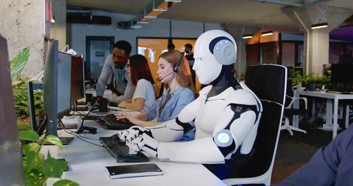 shutterstock_2229125163 Robot and office workers at computers in a modern workspace
