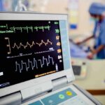Patient monitor displaying vital signs in a hospital room