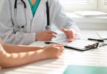 The Fastest Way To Repair Your Gut Naturally Doctor discusses medical notes with patient at a desk