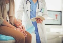 Brutal Cramps Explained – Hidden Trigger Exposed Doctor comforting patient while reviewing medical chart