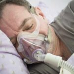 Man sleeping with a CPAP mask on his face