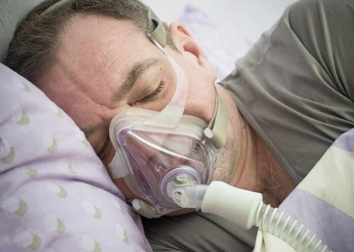 Man sleeping with a CPAP mask on his face