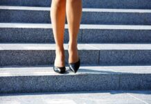 legs in black high heels walking down stone steps