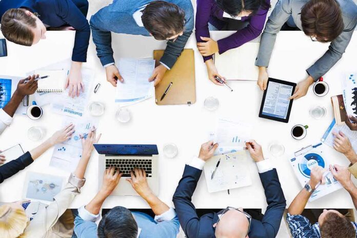 shutterstock_204774604 Group of professionals collaborating around a conference table