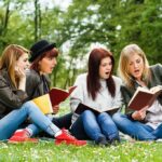 Hidden ADHD Crisis in Women Group of young women reading books on grass in a park