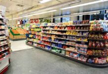 Dinner Staples Linked To Deadly Risks Supermarket aisle with shelves of snacks and candy